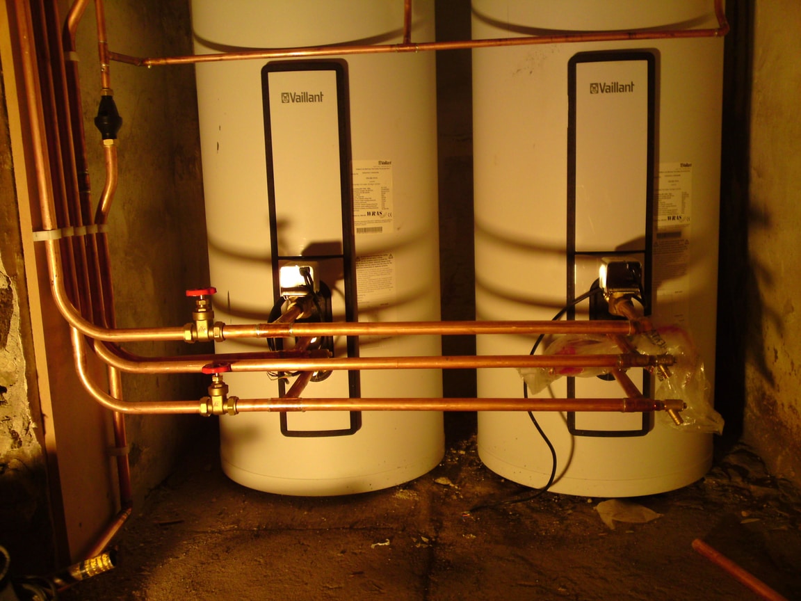 Newly installed boiler and hot-water cylinders with copper pipework in Holloway